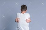 111273849-teenager-guy-hugging-himself-over-gray-background.jpg